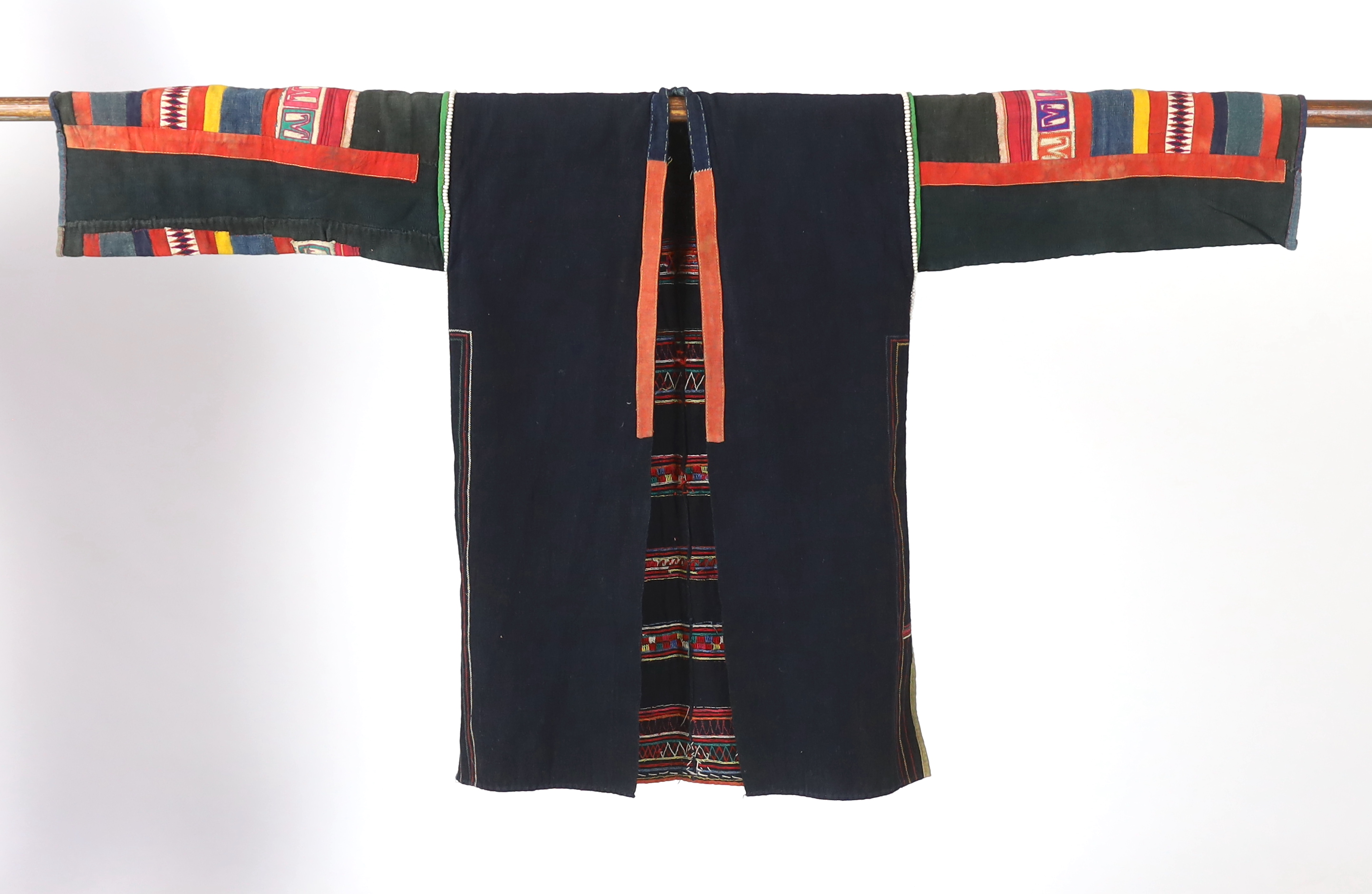 A Chiang Mai (Thailand) embroidered ladies three quarter length jacket, embroidered in hand dyed polychrome threads, (HKHA jacket) with beaded borders and spot design on a hand woven linen, 79cm long from neck to base